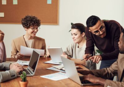 Business team meeting around a table with laptops