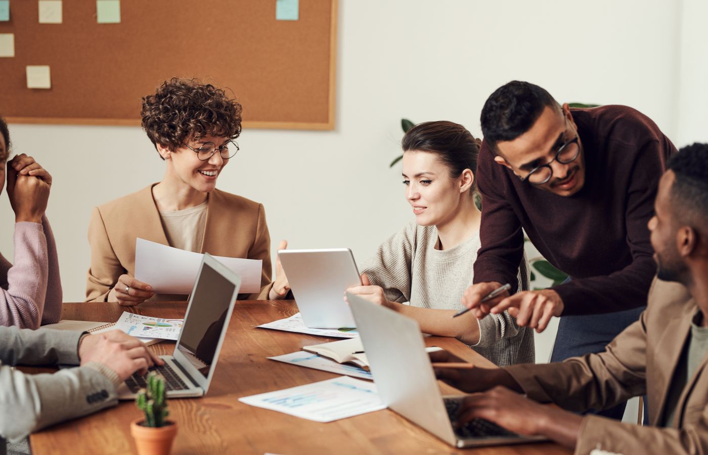 Business team meeting around a table with laptops